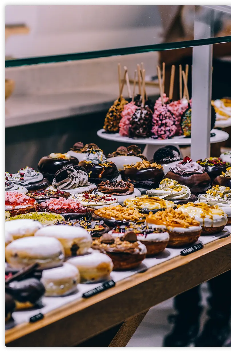 Assorted donuts and pastries in a bakery display